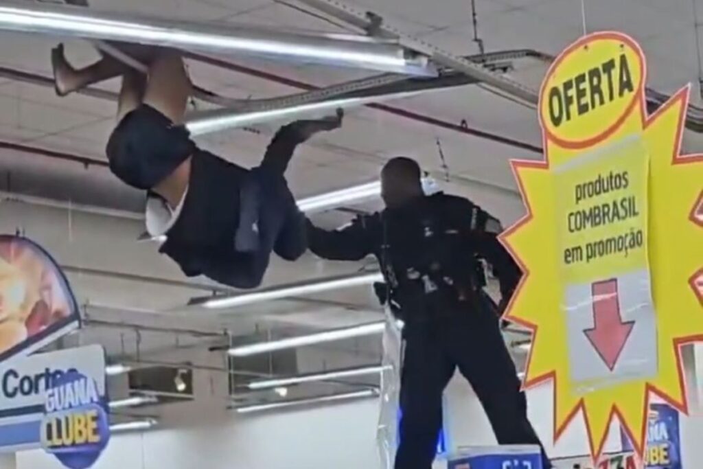 homem-e-contido-apos-se-pendurar-em-luminaria-de-supermercado.-video