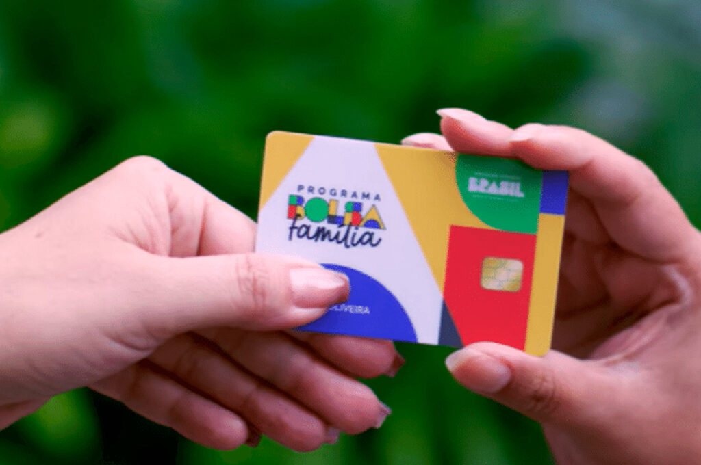 Cartão do Bolsa Família segurado por beneficiária.