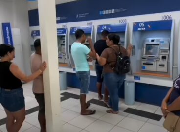 Fachada da agência da Caixa Econômica Federal no município de Sena Madureira com moradores aguardando atendimento.