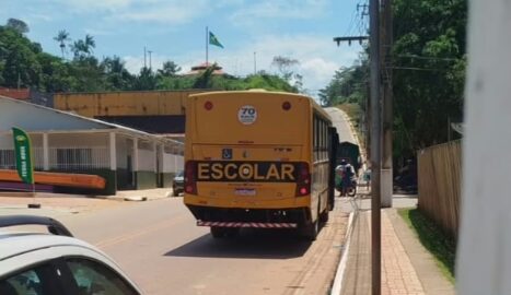 Pessoas embarcam em ônibus escolar durante agenda política em Assis Brasil, no Acre.